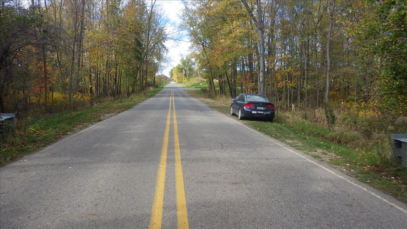 Park vehicles on either road shoulder just west of guardrail. Park vehicles on either road shoulder just west of guardrail.